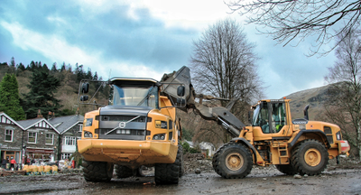 An SER Volvo L110F shovel loading an A30G dump truck reversing into the river at Glenridding