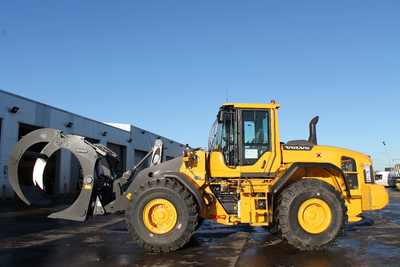 New Volvo L120G loading shovel with log grab for sawmill work.