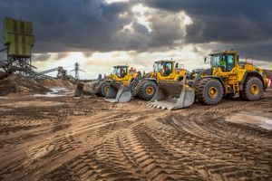 Volvo L150h, L180H and L260H loading shovels parked up on site.