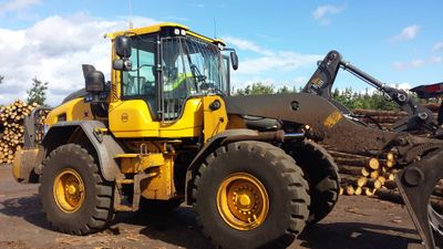 SER Volvo L90H loading shovel handling logs in a timber yard